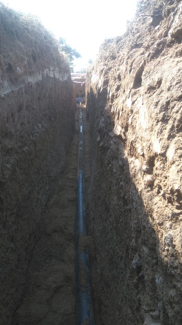 110mm HDPE main water supply installation across street for fuel station